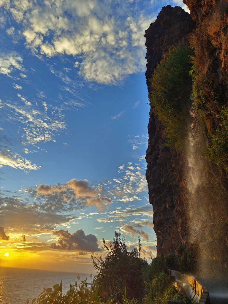 Breathtaking sunset view at Ponta do Sol, featuring dramatic cliffs and a cascading waterfall. One of the best sunset view on 10-day Madeira itinerary.